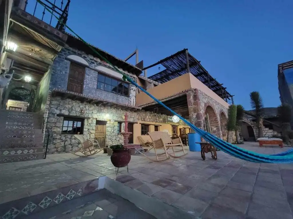 Stone courtyard of Hotel Rincón Mágico at dusk